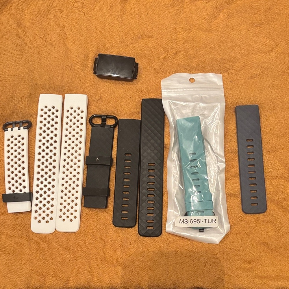 Fitbit charge 3 w/ extra bands in Black, White, and aqua
